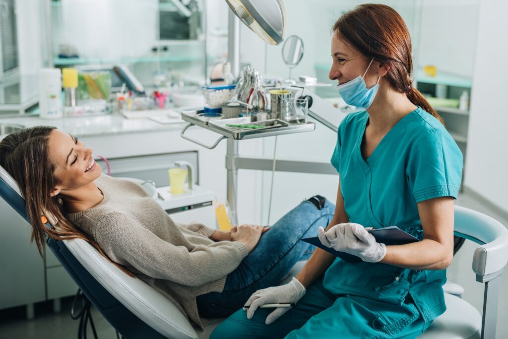 patient and dental assistant smiling and laughing